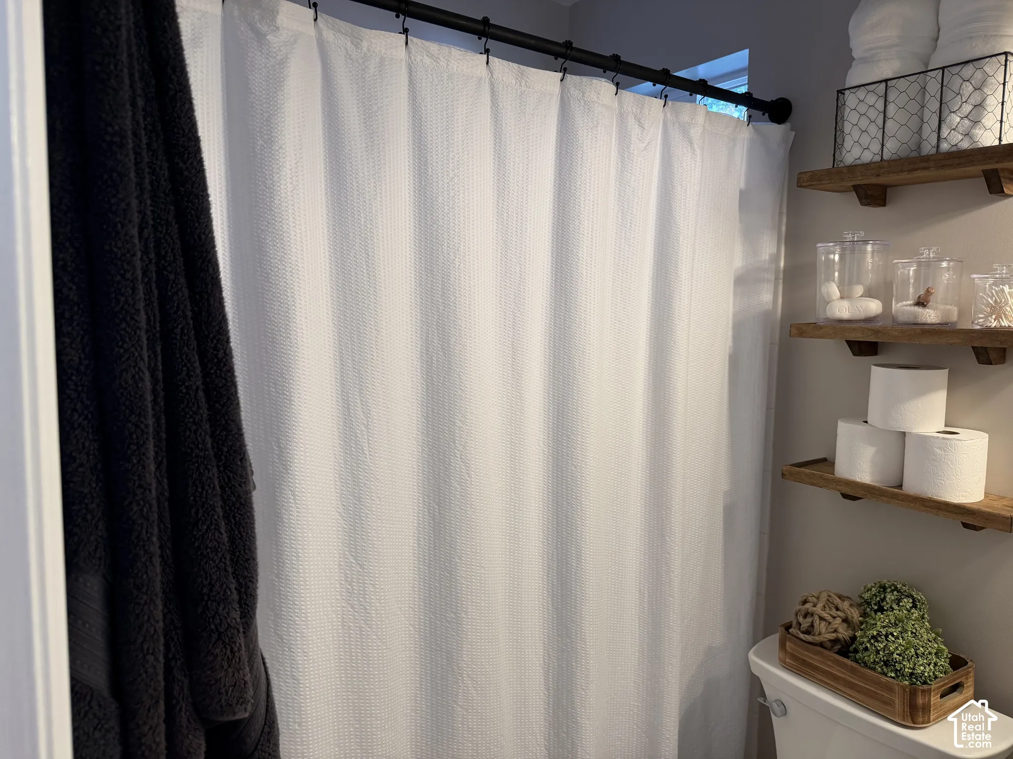 Wall-mounted wood-finish shelving provides storage options