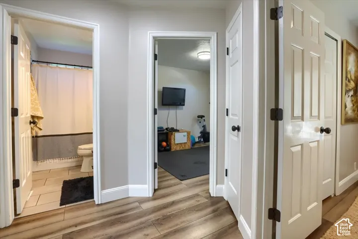 Wood-finish flooring extending into the hallway