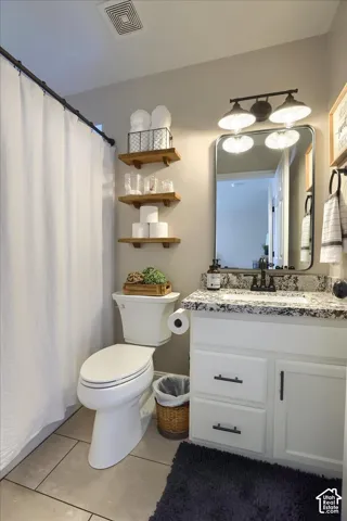 White vanity with black hardware and an integrated sink