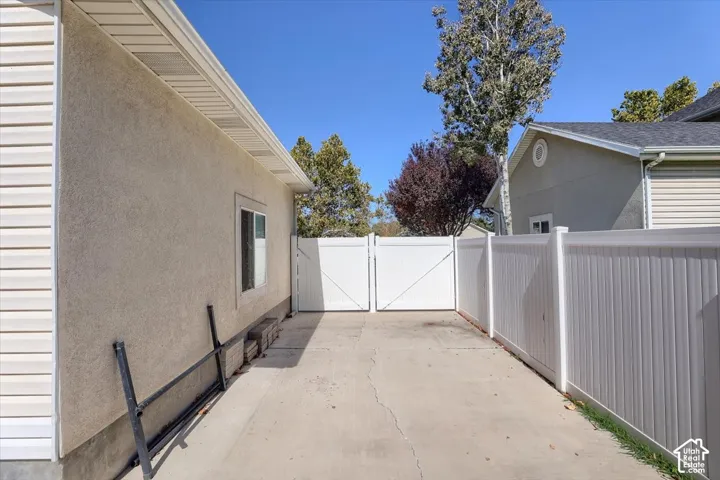 Paved side yard with privacy fencing and double gate access