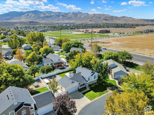 Community setting with established landscaping, paved roadways, and distant mountain ranges