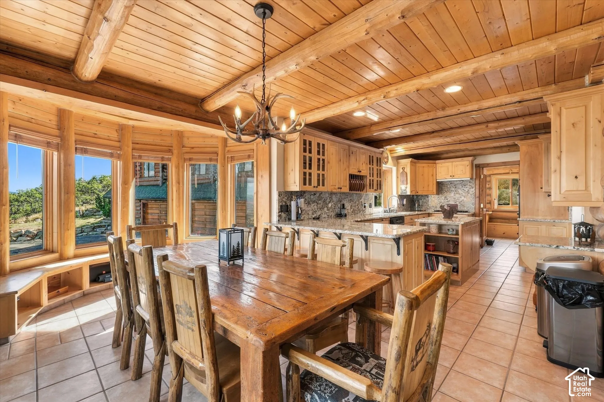 Wood-paneled ceilings, timber beam accents, and tiled flooring