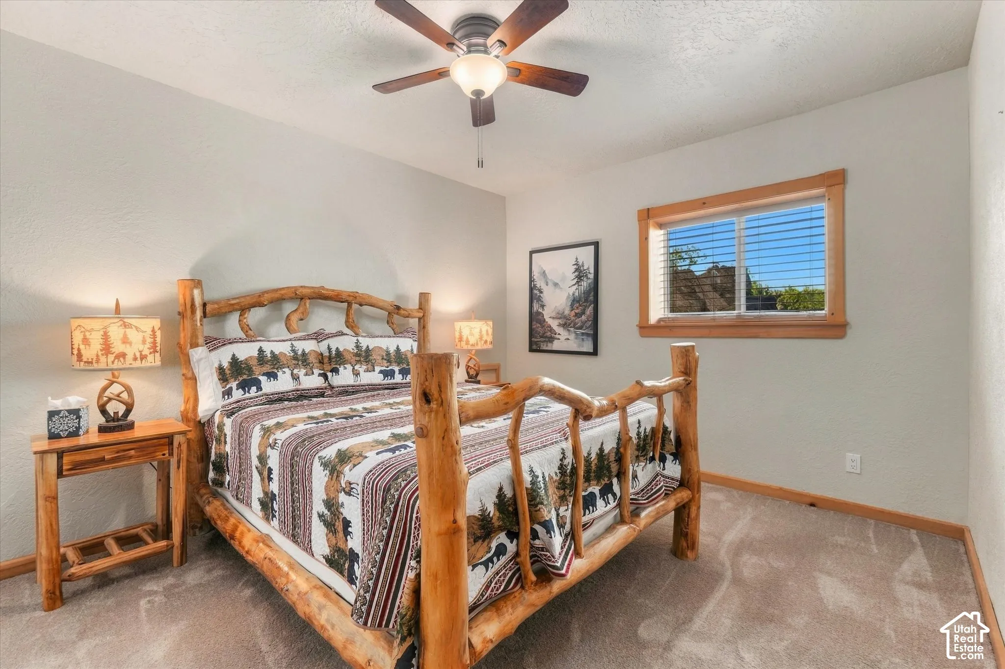 Carpeted flooring, a window with wood trim, and a ceiling fan with integrated lighting