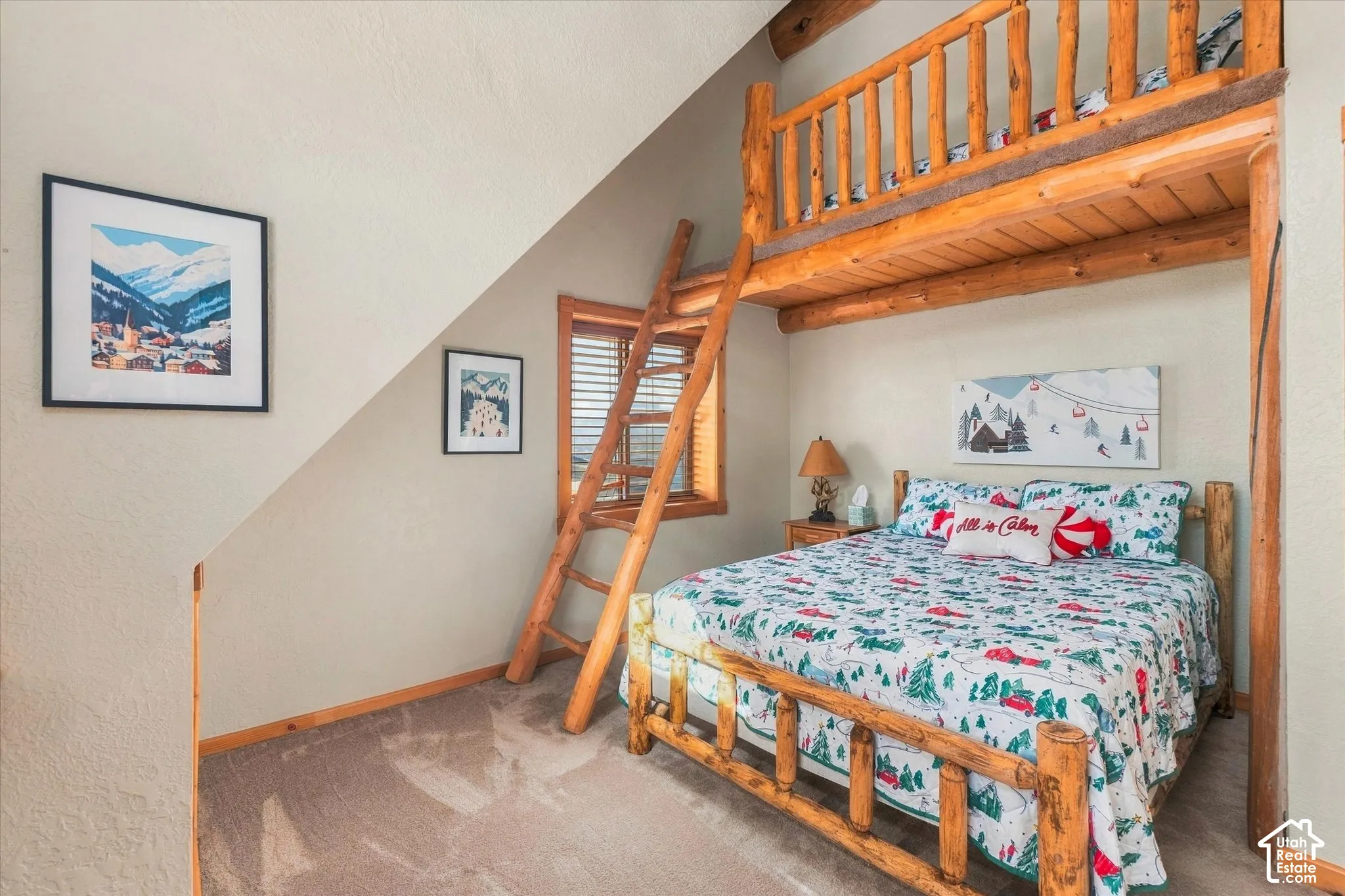 Built-in log bunk bed with ladder, wood-finish window blinds, and neutral carpet flooring