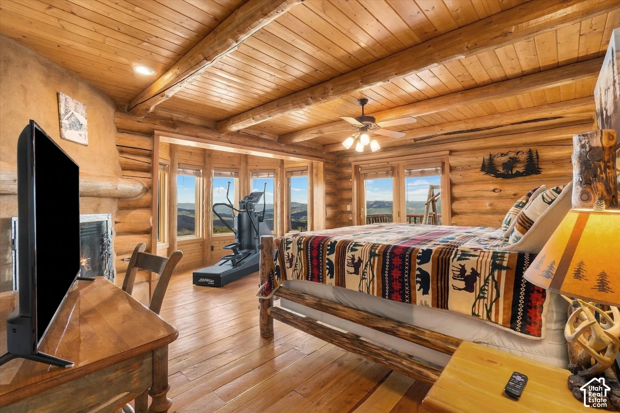 Wood-paneled ceilings, log walls, and wood-finish flooring characterize this room