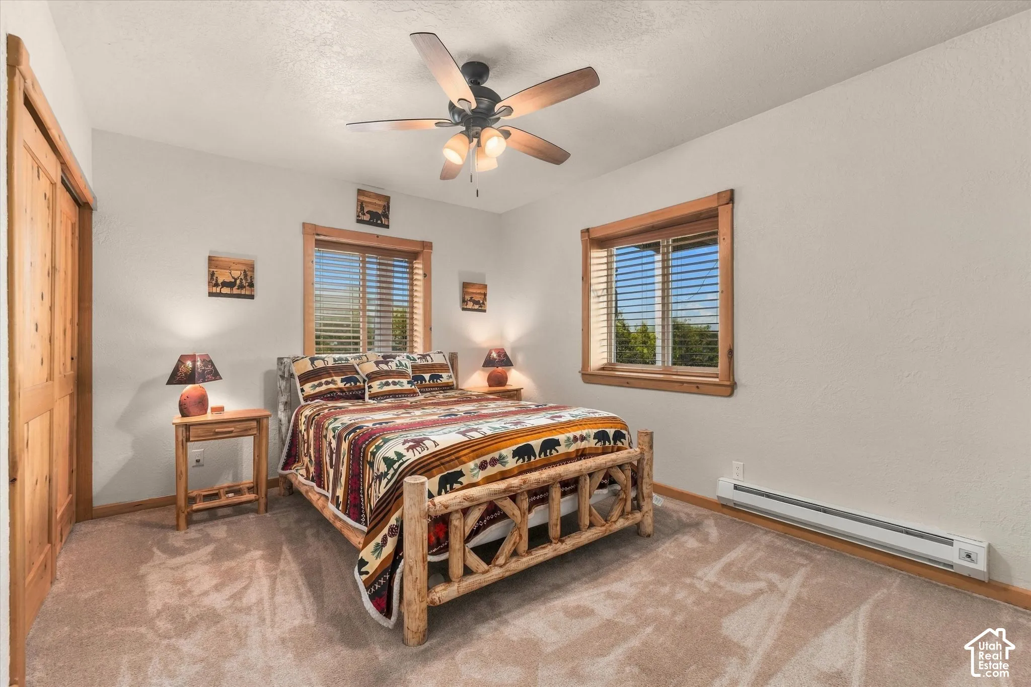 Wall-to-wall carpeting, wood-trimmed windows with blinds, and a ceiling fan with integrated lighting