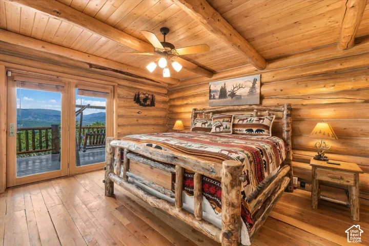 Wood-paneled walls and ceiling with exposed log beams