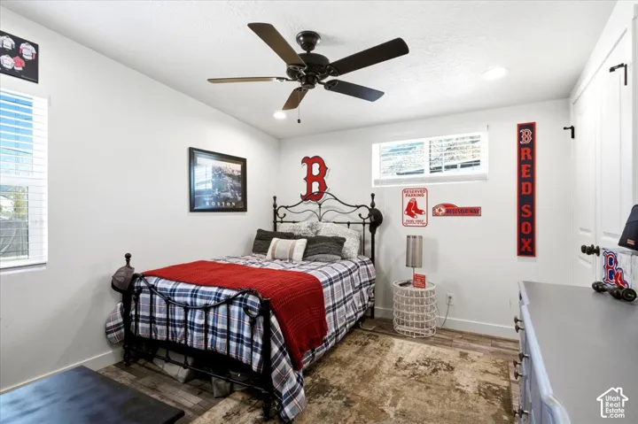 Recessed lighting, ceiling fan, wood-finish flooring, white walls, and a window with blinds