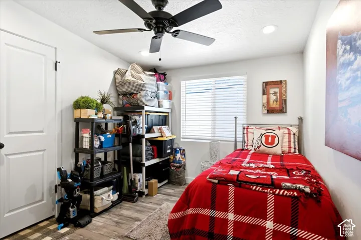 Recessed lighting, ceiling fan, wood-finish flooring, and white walls