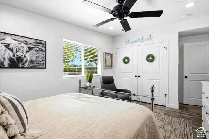 White walls, wood-finish flooring, and recessed lighting create a bright interior