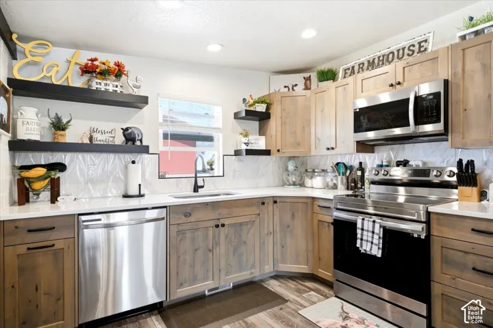 Wood-finish cabinetry paired with white countertops, stainless steel appliances, and a tiled backsplash