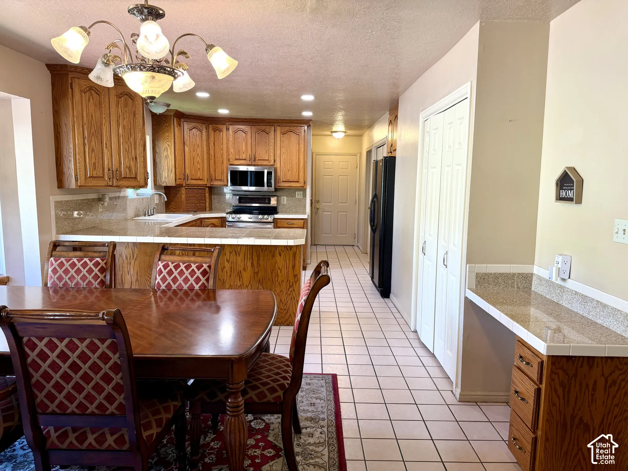 Kitchen featuring wood cabinetry, stainless steel appliances, and a tile backsplash