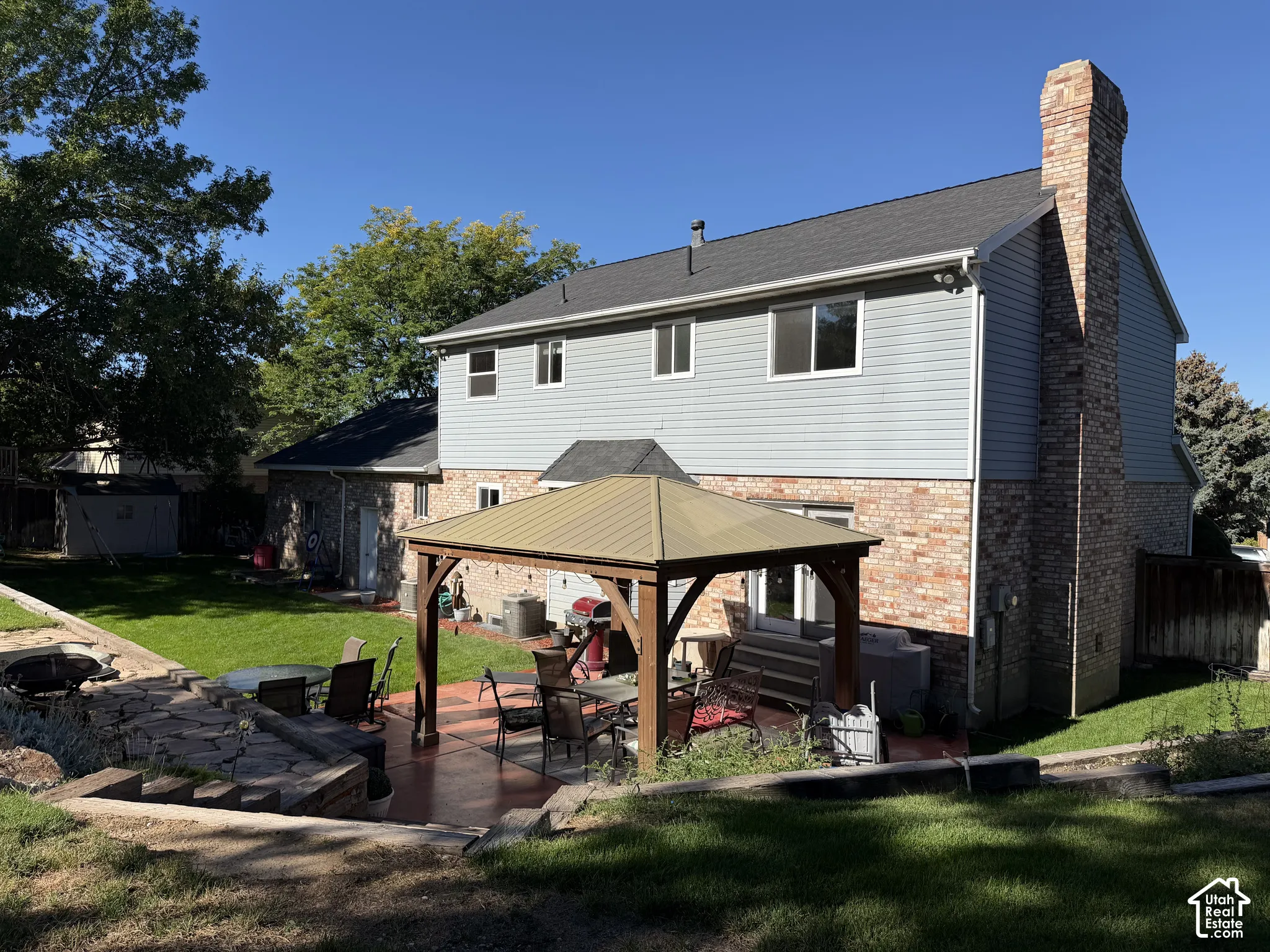 Spacious backyard featuring a  covered gazebo, and a manicured lawn