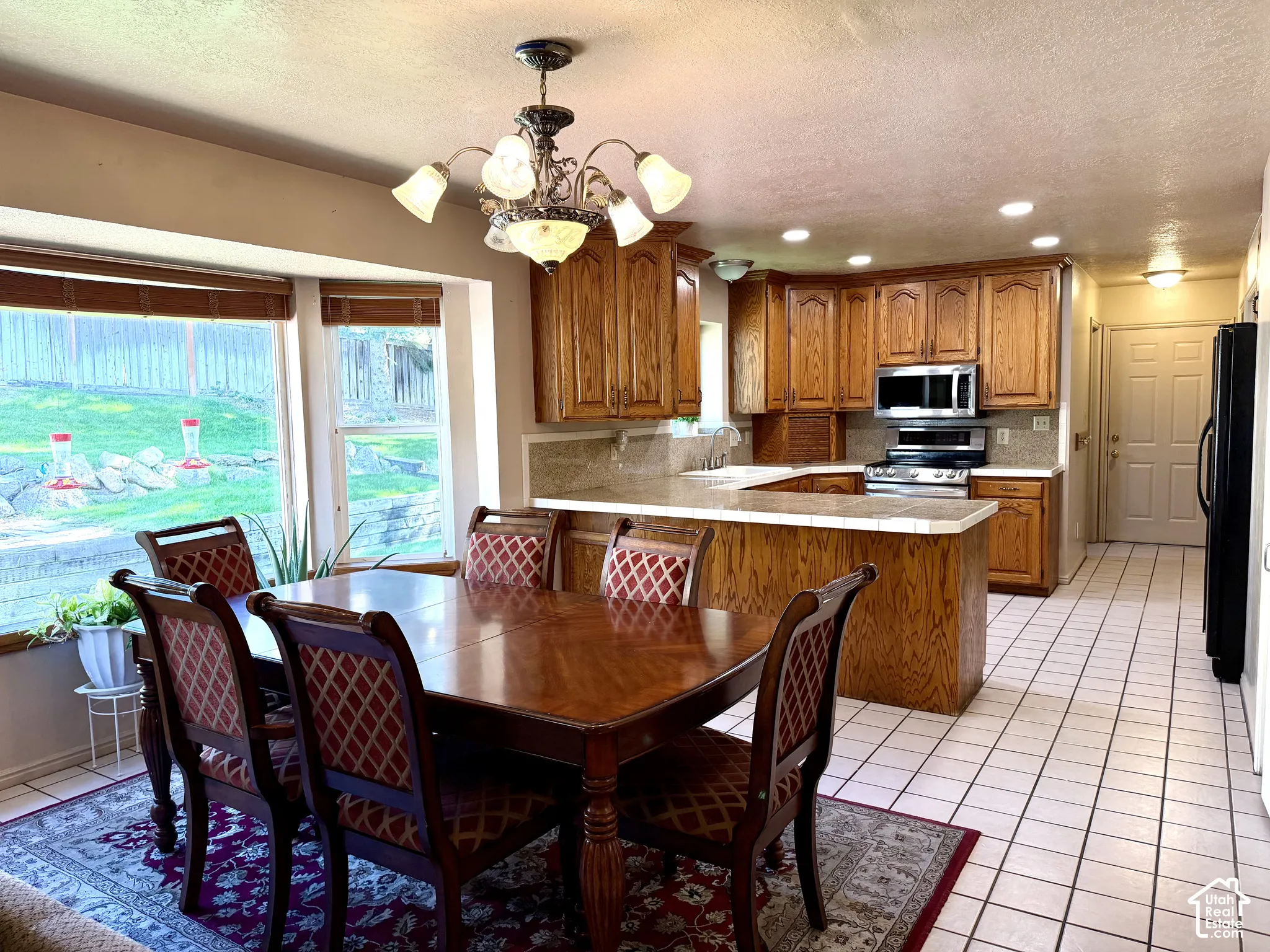 Kitchen with wood cabinetry, stainless steel appliances, and a built-in island
