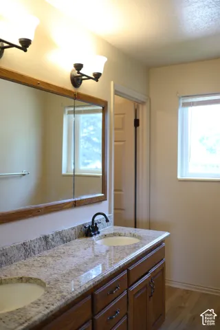 Hall Bathroom with double sinks and separate shower and toilet