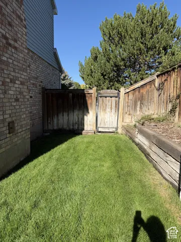 Wood gate entrance to back yard on north side of house