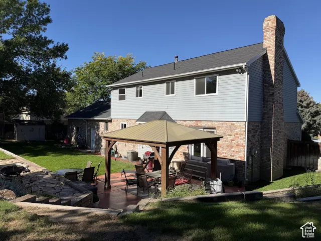 Spacious backyard featuring a  covered gazebo, and a manicured lawn
