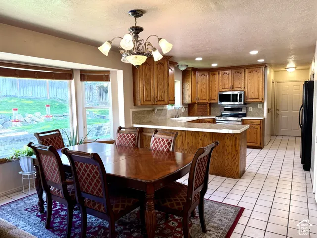 Kitchen with wood cabinetry, stainless steel appliances, and a built-in island
