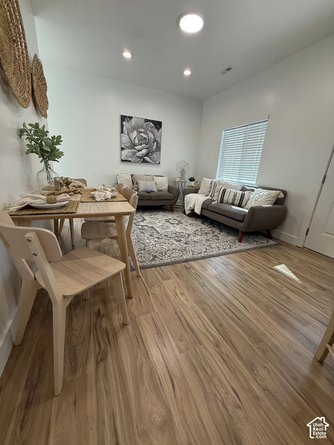 Wood-finish flooring, recessed lighting, and a window with blinds