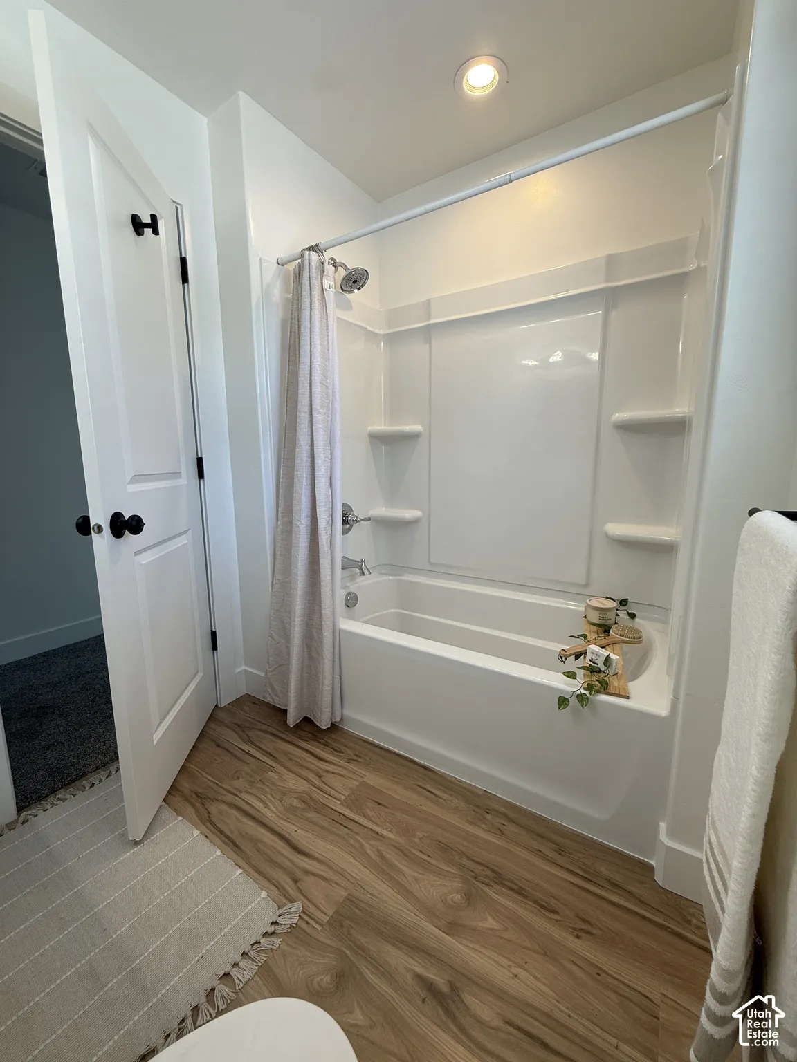 Tub and shower combination with a white surround and chrome fixtures