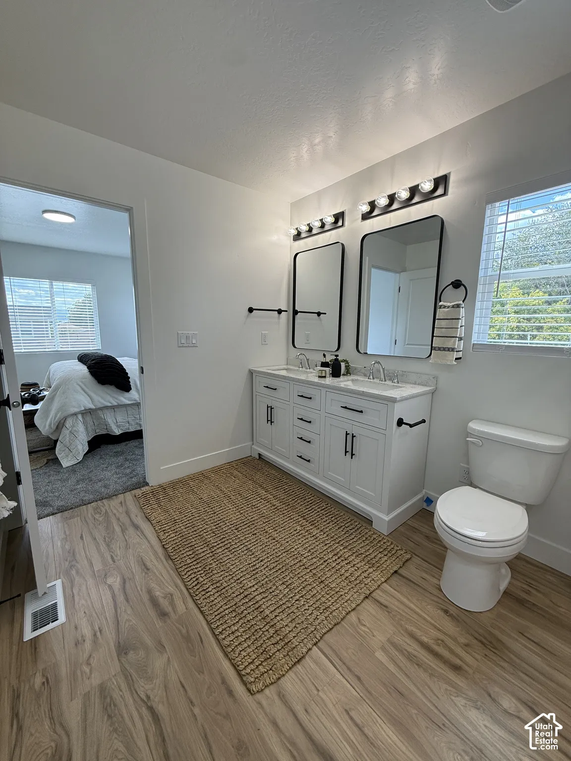 Dual vanity with stone-finish countertops and undermount sinks