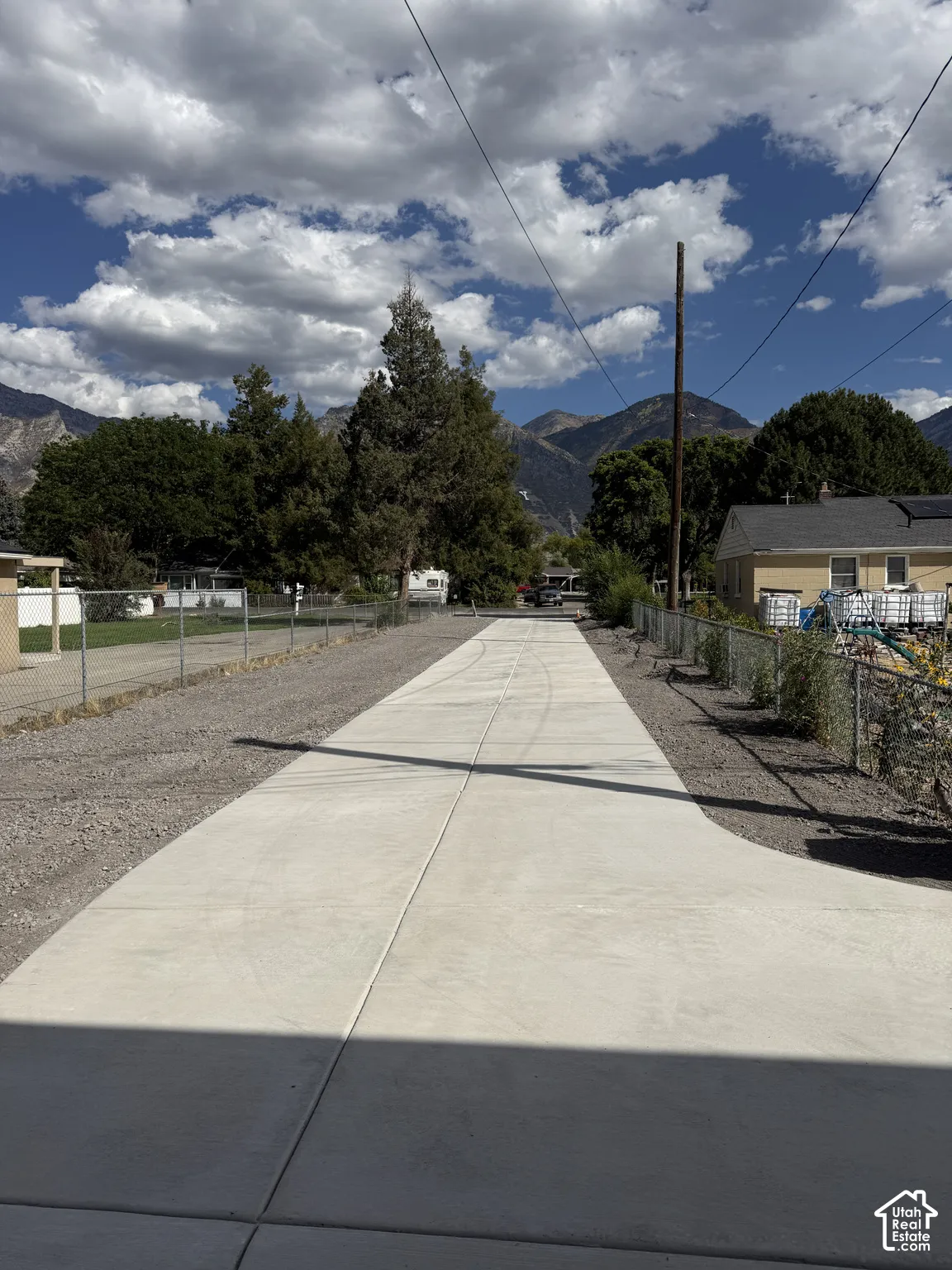 Paved concrete driveway with gravel borders