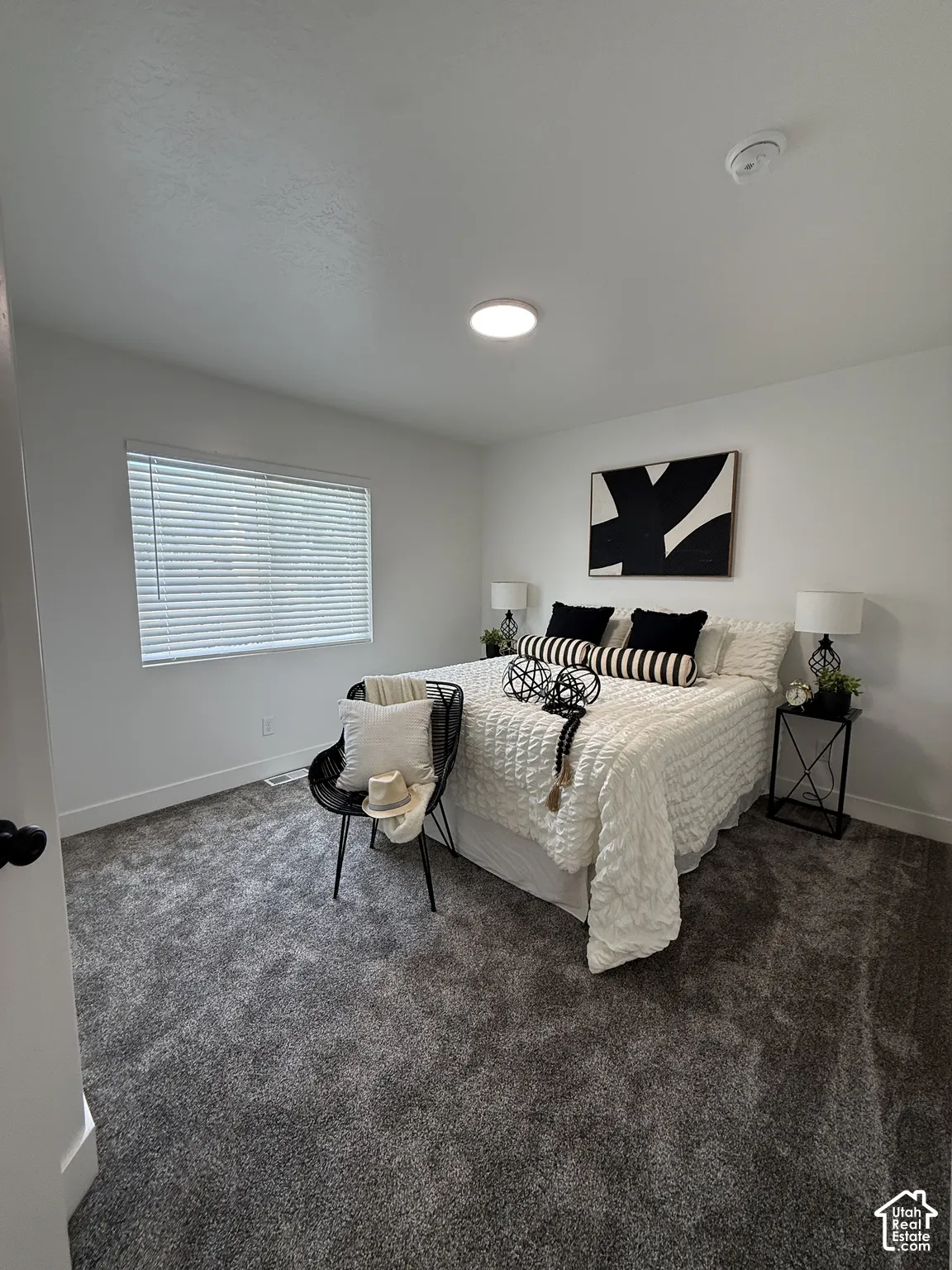 White walls, recessed ceiling lighting, and gray carpeting
