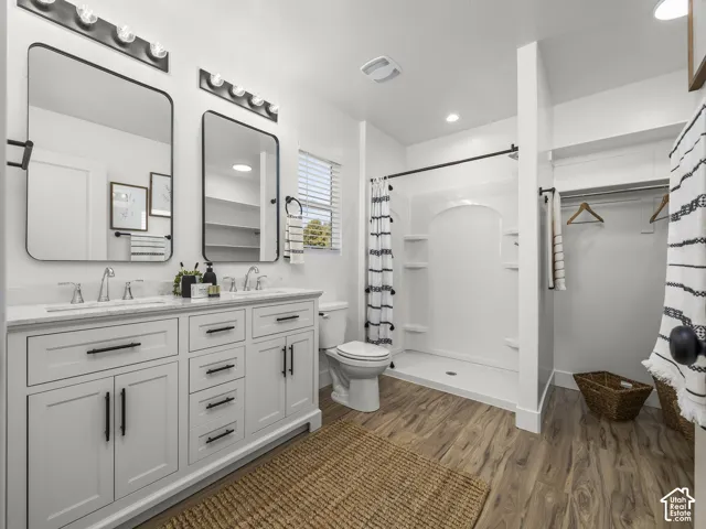 Dual vanity with white cabinetry, polished chrome fixtures, and rectangular mirrors
