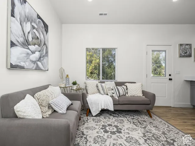 Recessed lighting, wood-finish flooring, and white painted walls