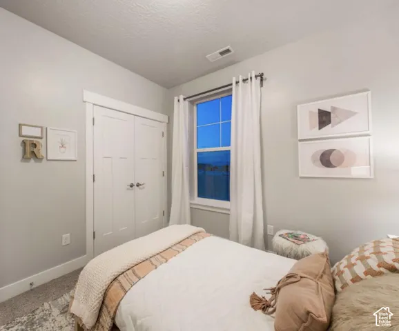 Recessed lighting, window with white curtains, bi-fold closet doors, carpeted flooring