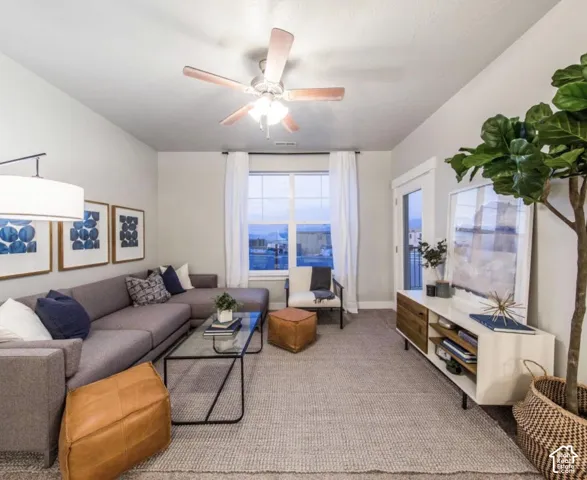 Recessed lighting, ceiling fan, large window, glass-top coffee table, and built-in media console