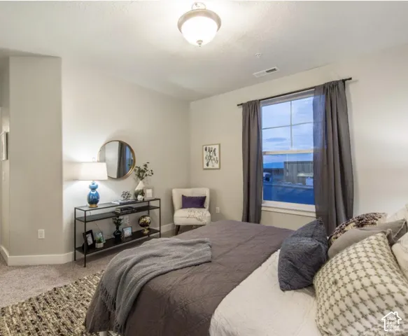 Carpeted flooring, recessed window, ceiling-mounted light fixture, and light-toned walls