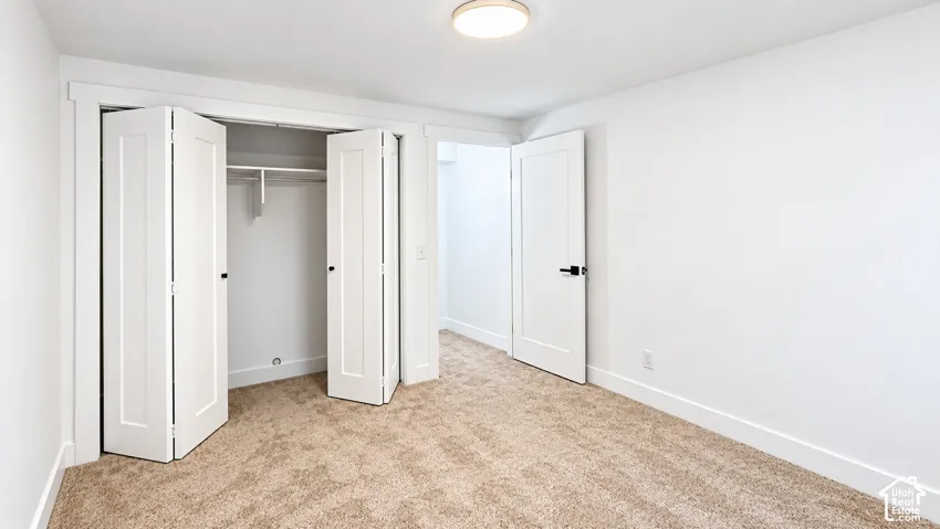 Plush carpeting, white walls, and bright overhead lighting