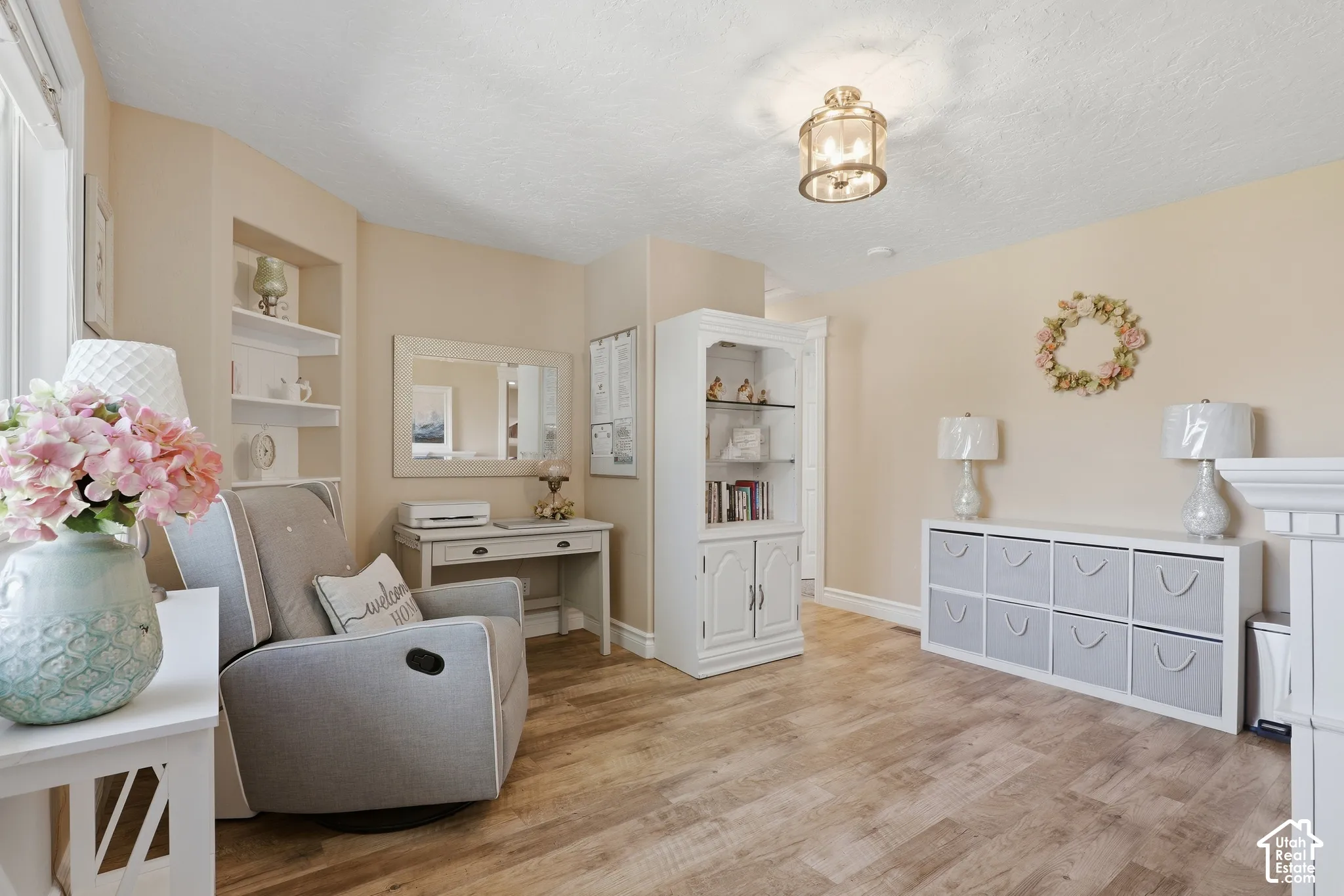 Wood-finish flooring, recessed shelving, built-in desk, and a semi-flush mount ceiling light