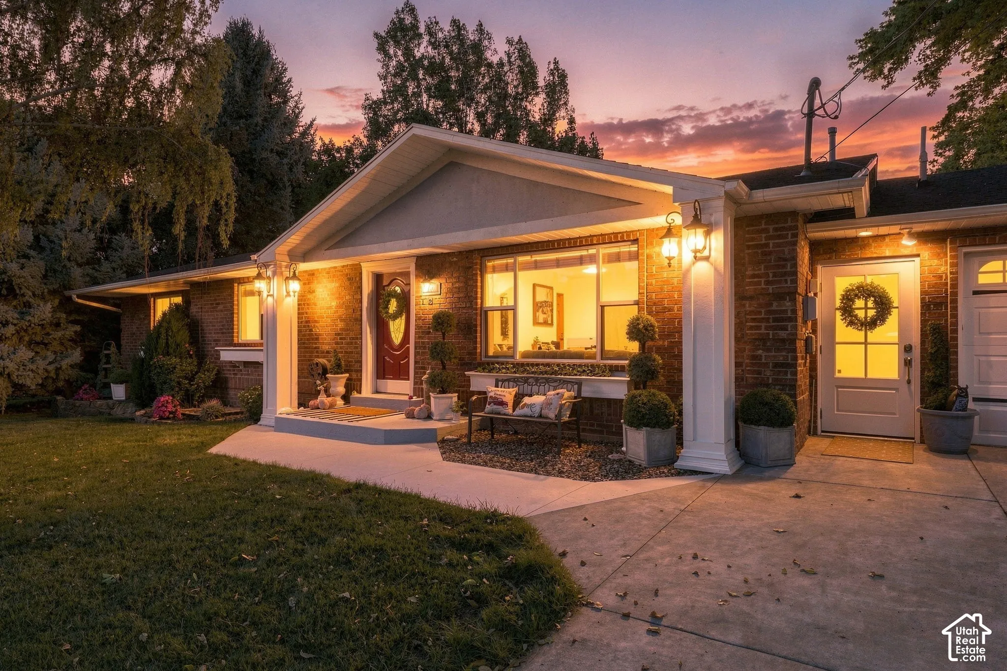 Brick exterior with a prominent entry, large picture window, and a concrete driveway