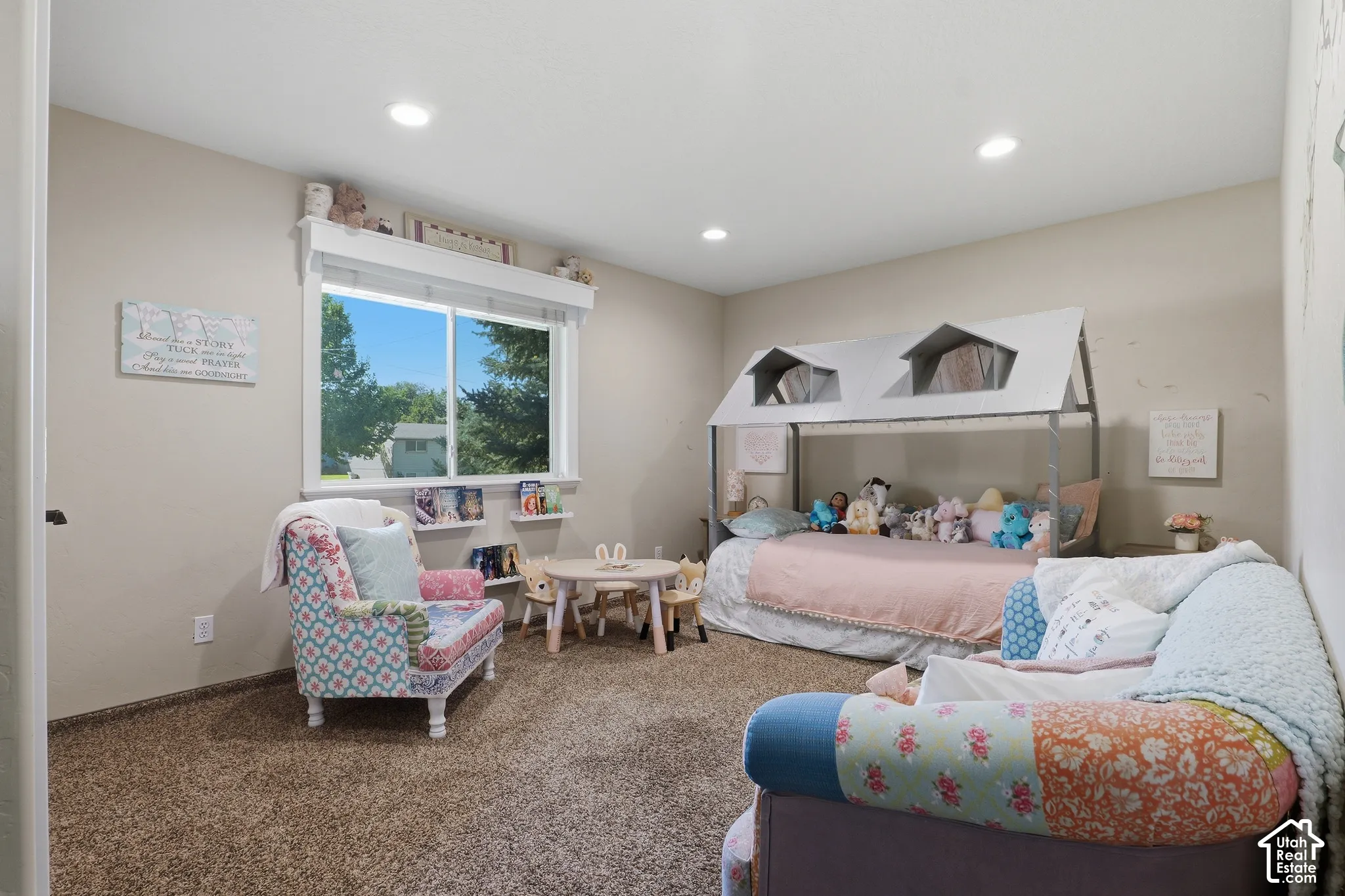 Recessed lighting illuminates neutral-toned walls and carpeted flooring