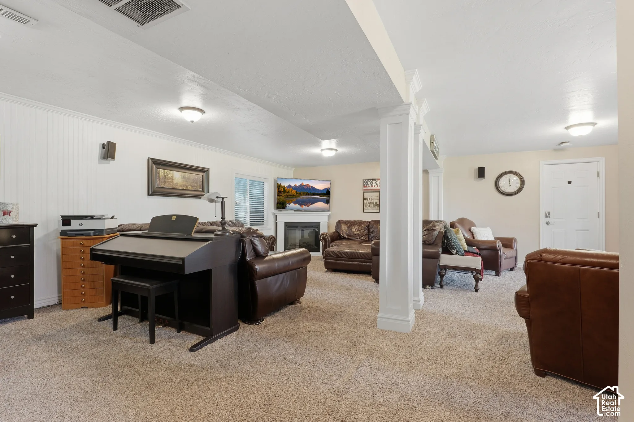 Recessed lighting, fireplace with mantel, sliding glass door, white wainscoting, and carpeted flooring