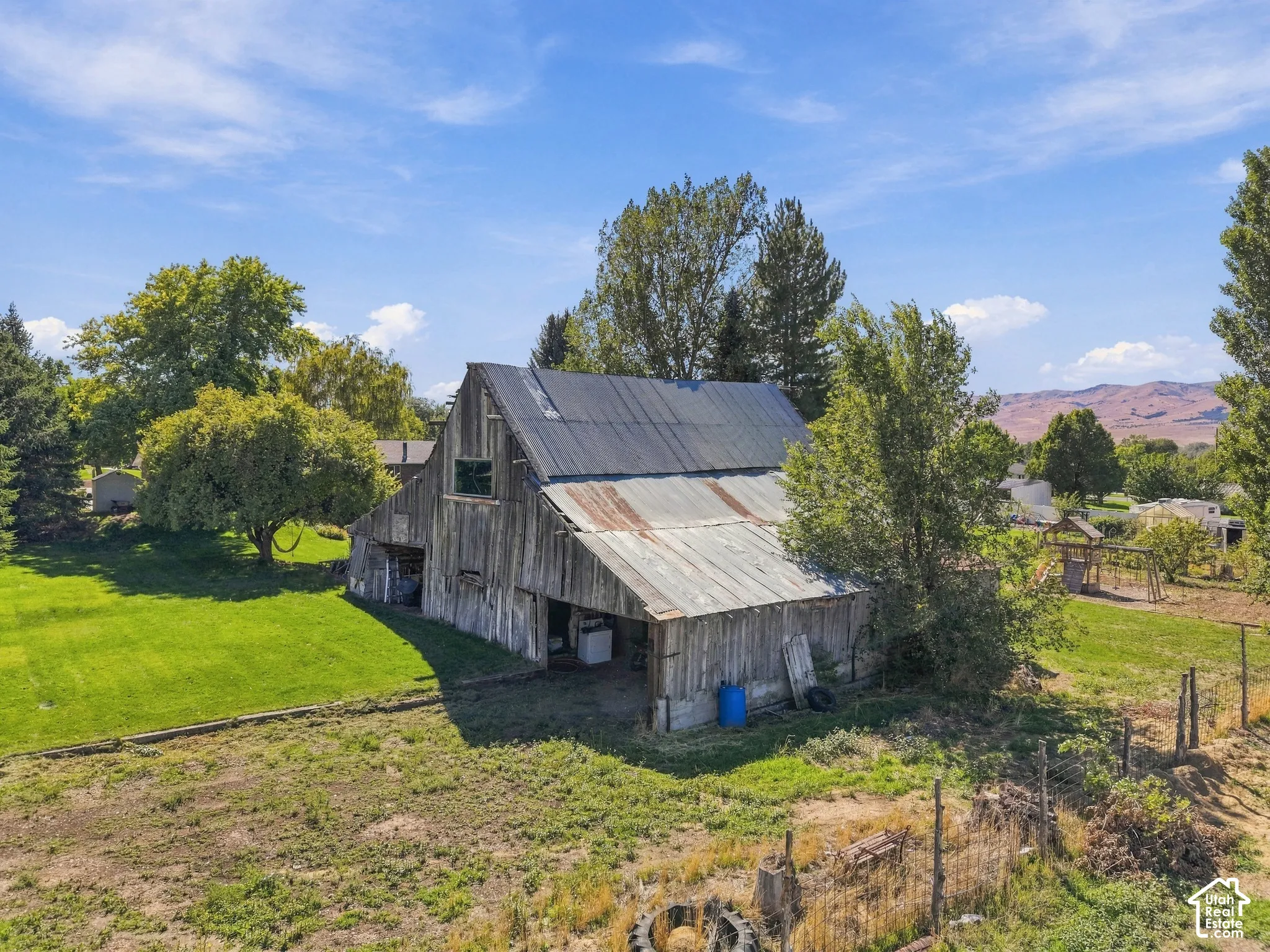 Barn structure featuring wood siding and a corrugated metal roof