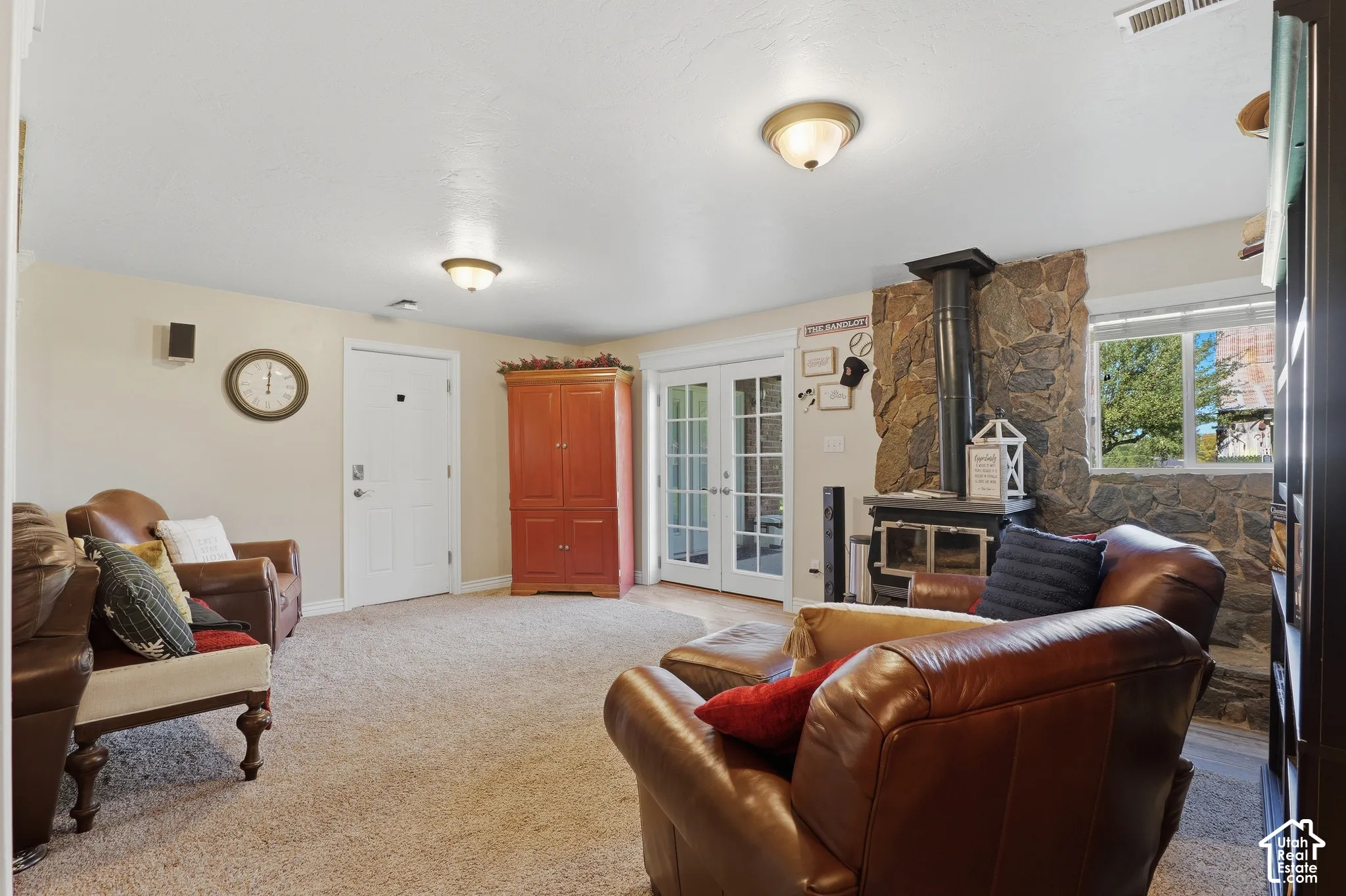 Stone accent wall featuring a wood-burning stove