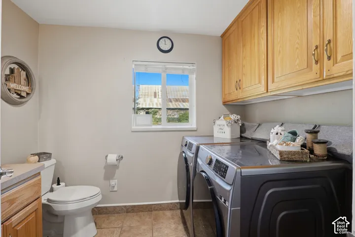 Utility room featuring wood cabinetry, a built-in countertop, and a window