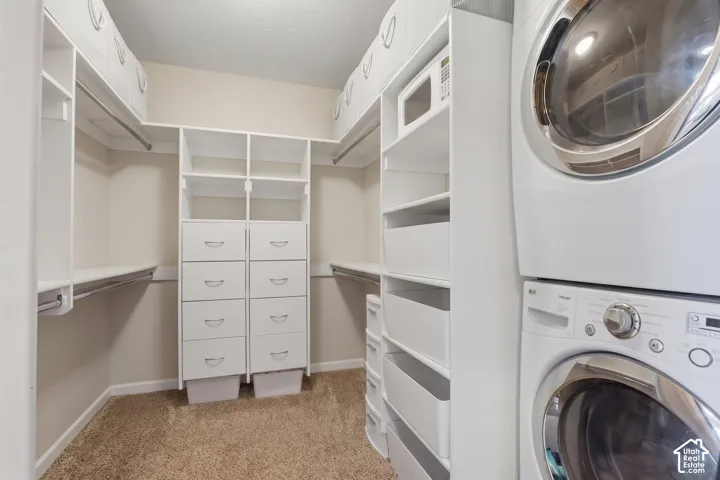 Walk-in closet with integrated shelving, drawer storage, and hanging rods