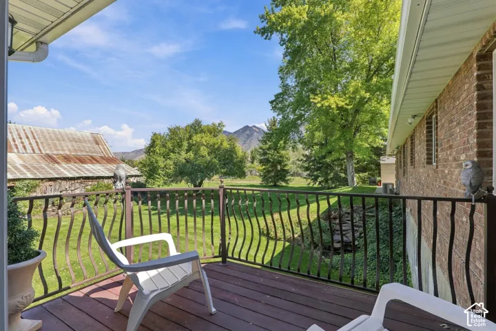 Deck with composite decking, wrought iron railing, and brick exterior