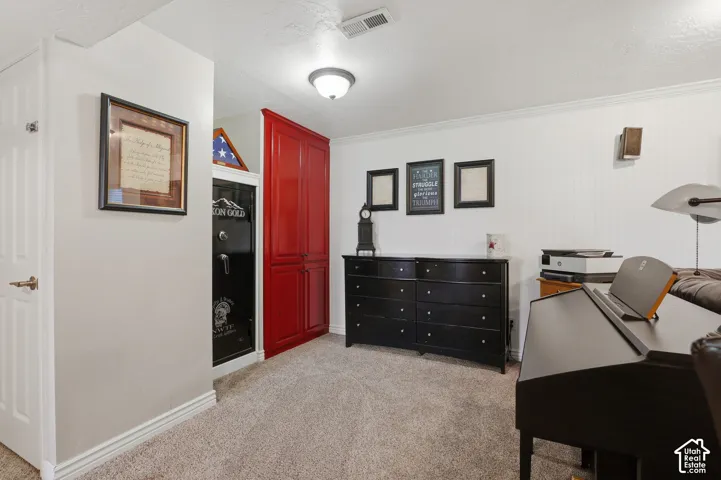 Built-in red cabinetry, wall-mounted speaker, and textured wall paneling