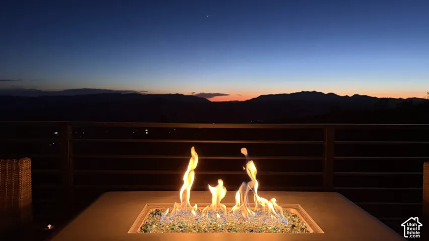 Outdoor fire feature with decorative fire glass, integrated into an exterior surface