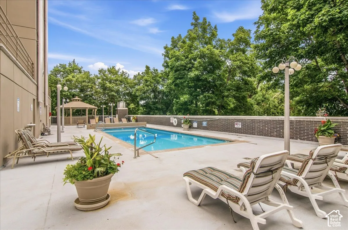 Outdoor swimming pool with integrated steps, surrounded by a concrete deck