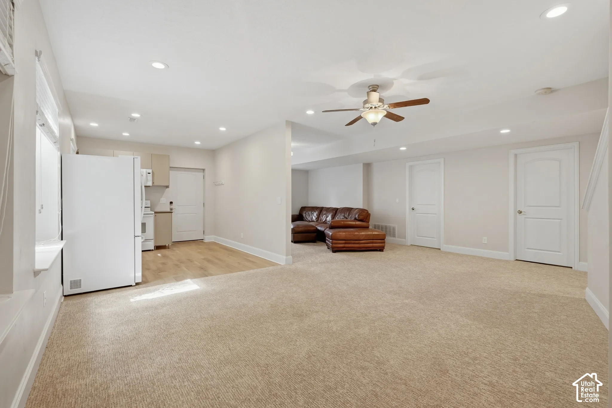 Open-concept living area featuring recessed lighting, a ceiling fan, and carpeted flooring