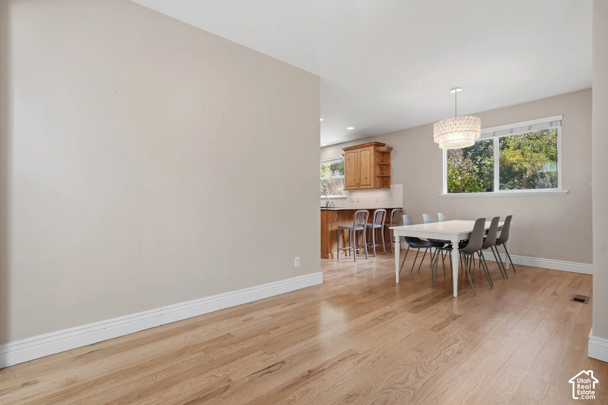 Light wood-finish flooring throughout, complemented by crisp white baseboards
