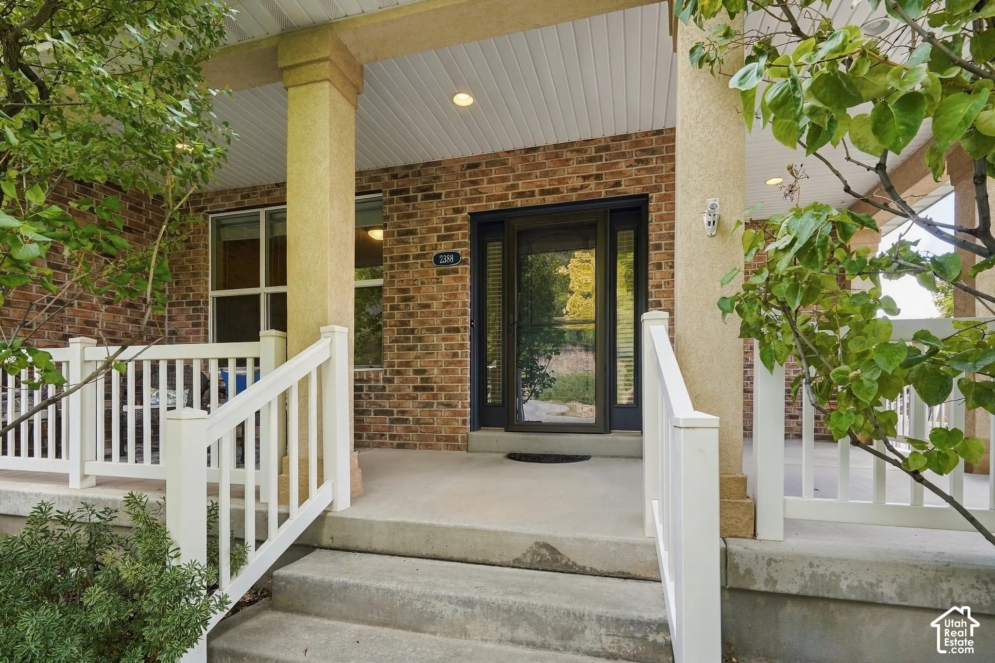 Brick exterior with concrete steps and porch