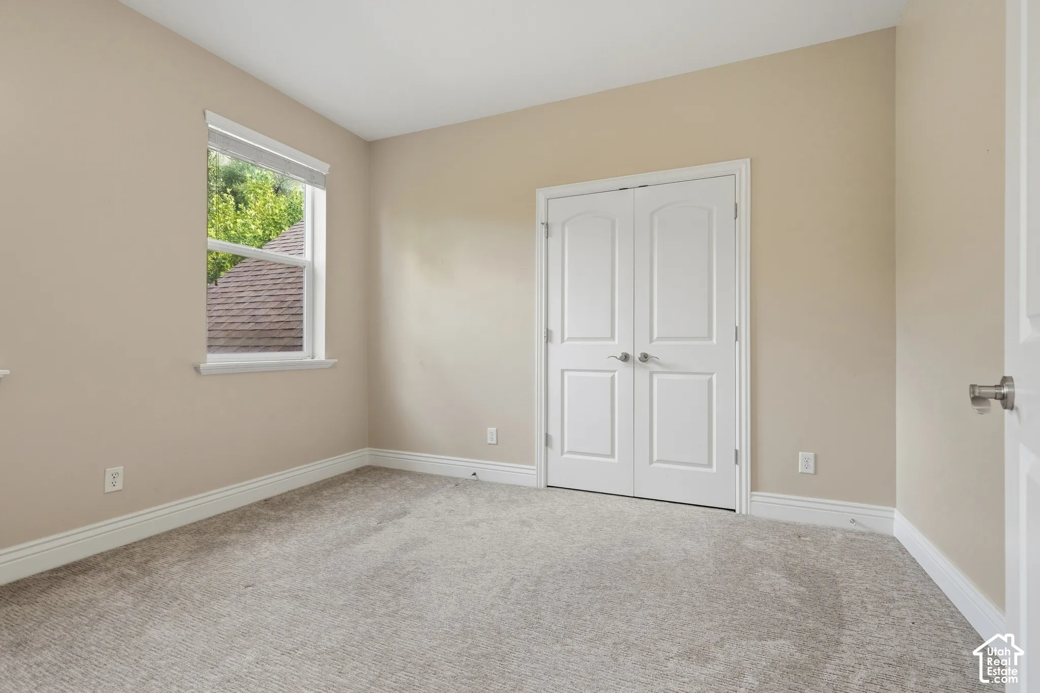 Neutral-toned walls complement the light-colored carpeting