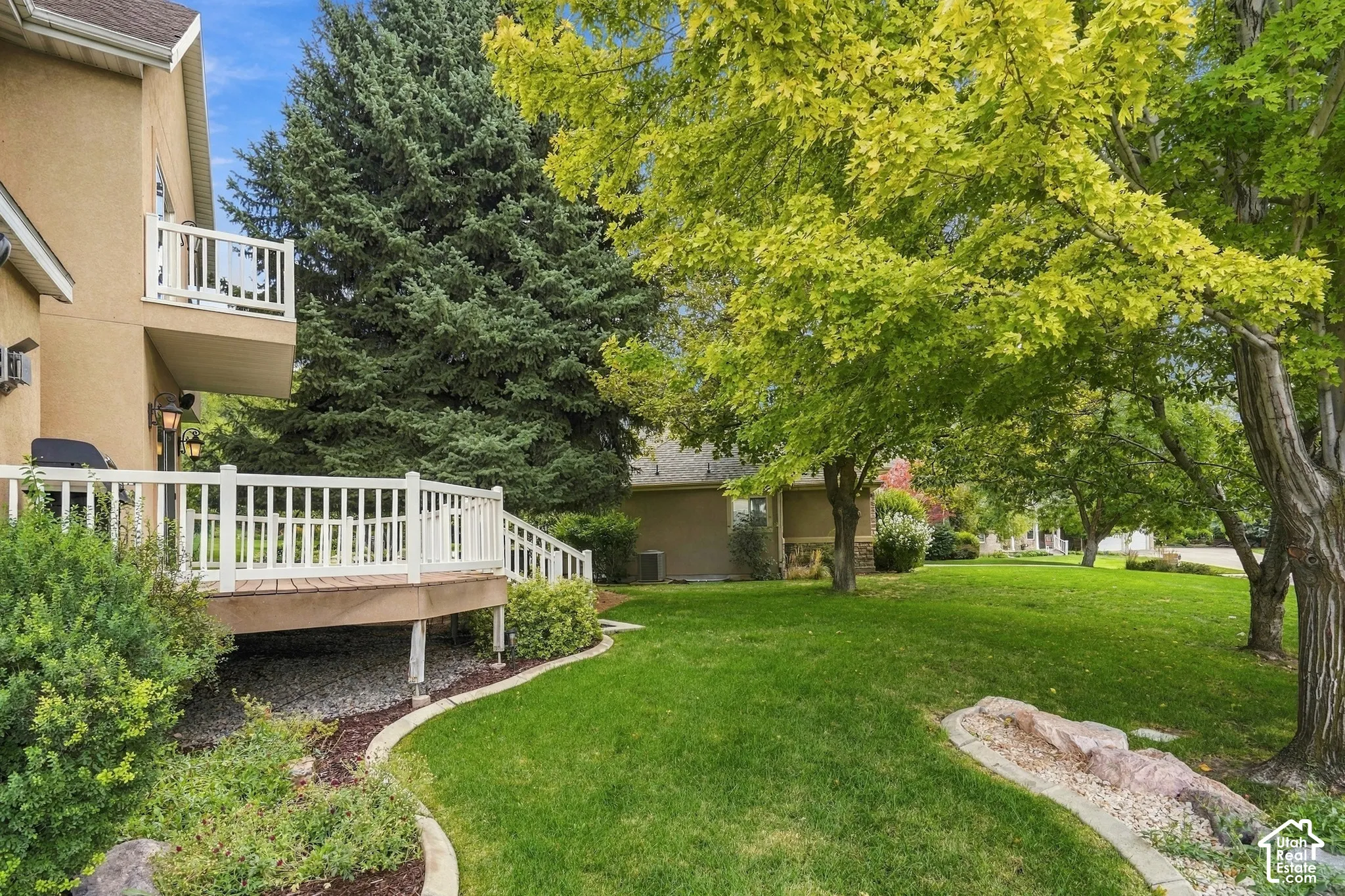 Expansive green lawn with mature trees